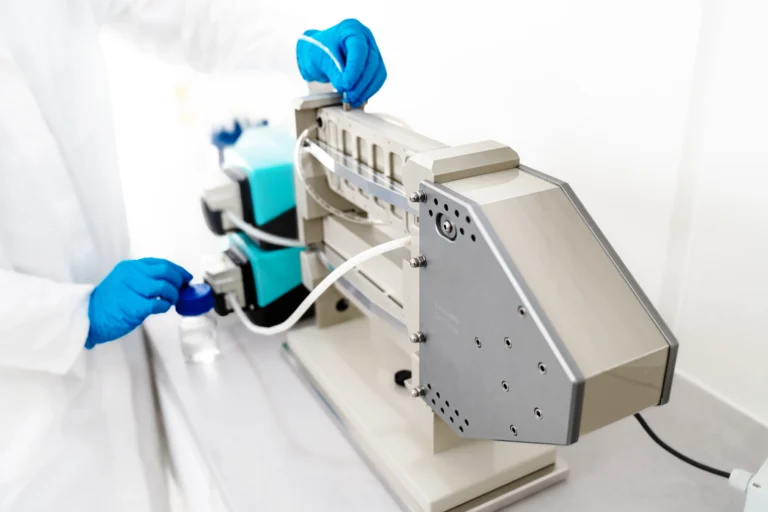 A person operating a Vibro-Lab280 set up with watson marlow pumps